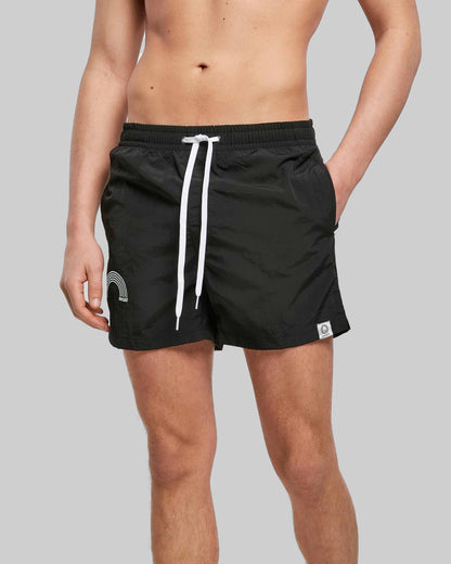 EINHORST® Schwimm- & Sportshorts mit dem Motiv "pride-Regenbogen" in der Farbe "Black", Bild von einer männlichen Person von vorne, die die Shorts trägt