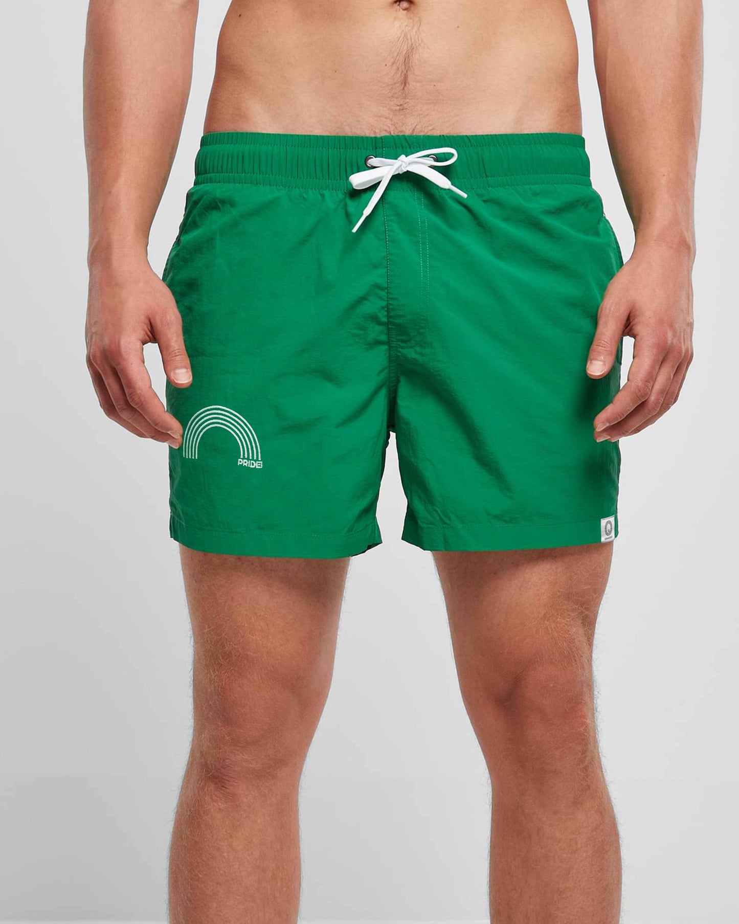 EINHORST® Schwimm- & Sportshorts mit dem Motiv "pride-Regenbogen" in der Farbe "Forestgreen", Bild von einer männlichen Person von vorne, die die Shorts trägt
