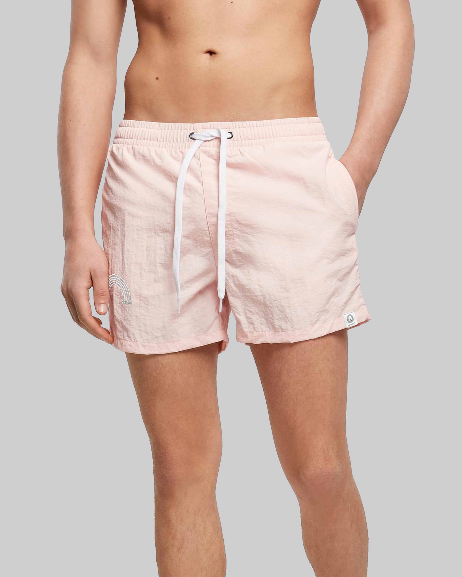 EINHORST® Schwimm- & Sportshorts mit dem Motiv "pride-Regenbogen" in der Farbe "Pink", Bild von einer männlichen Person von vorne, die die Shorts trägt